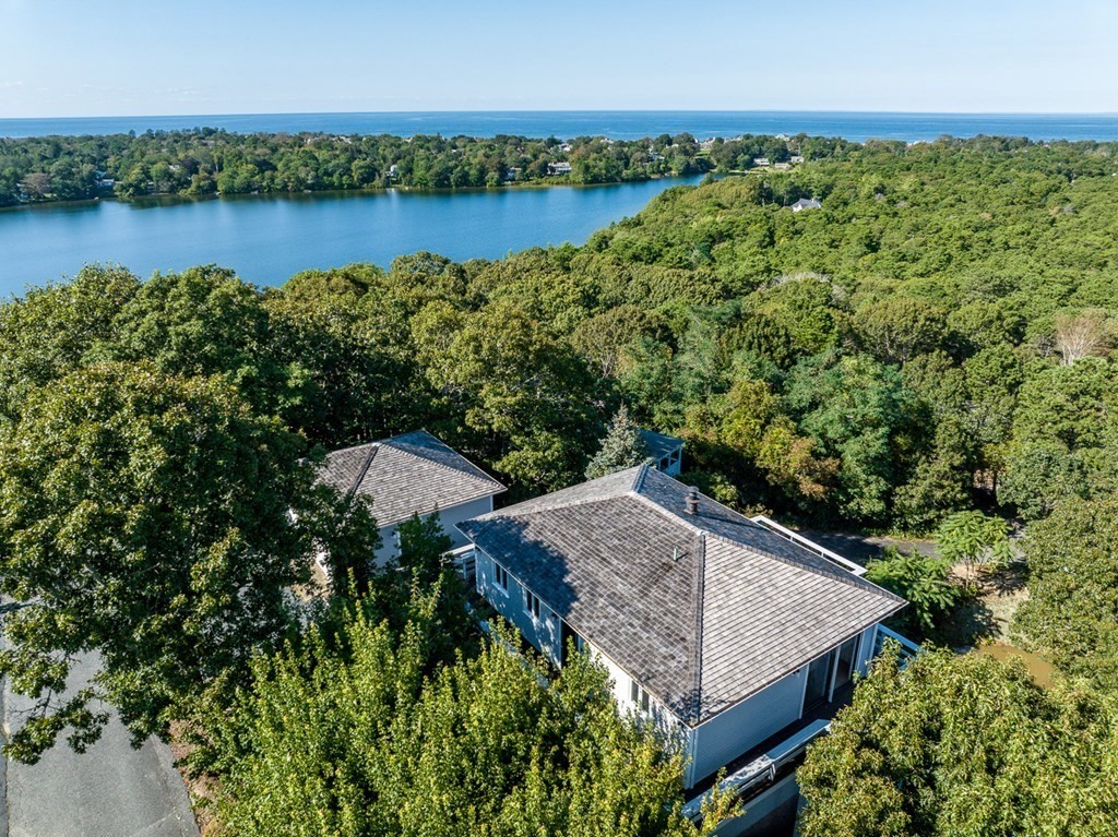 an aerial view of a house with a yard and lake view