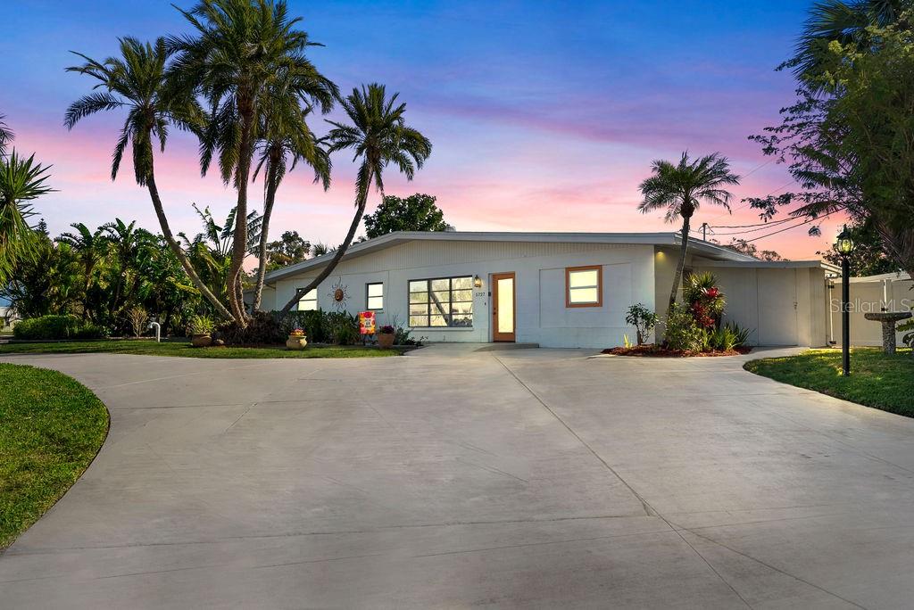 a view of house with yard and entertaining space