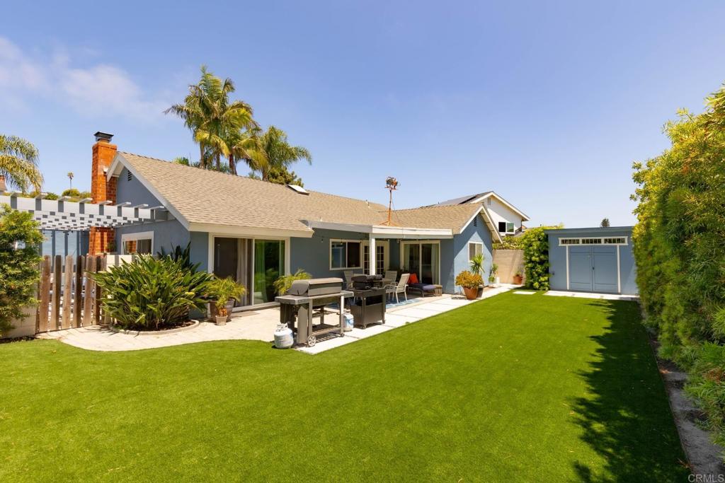 a view of a house with sitting area and garden