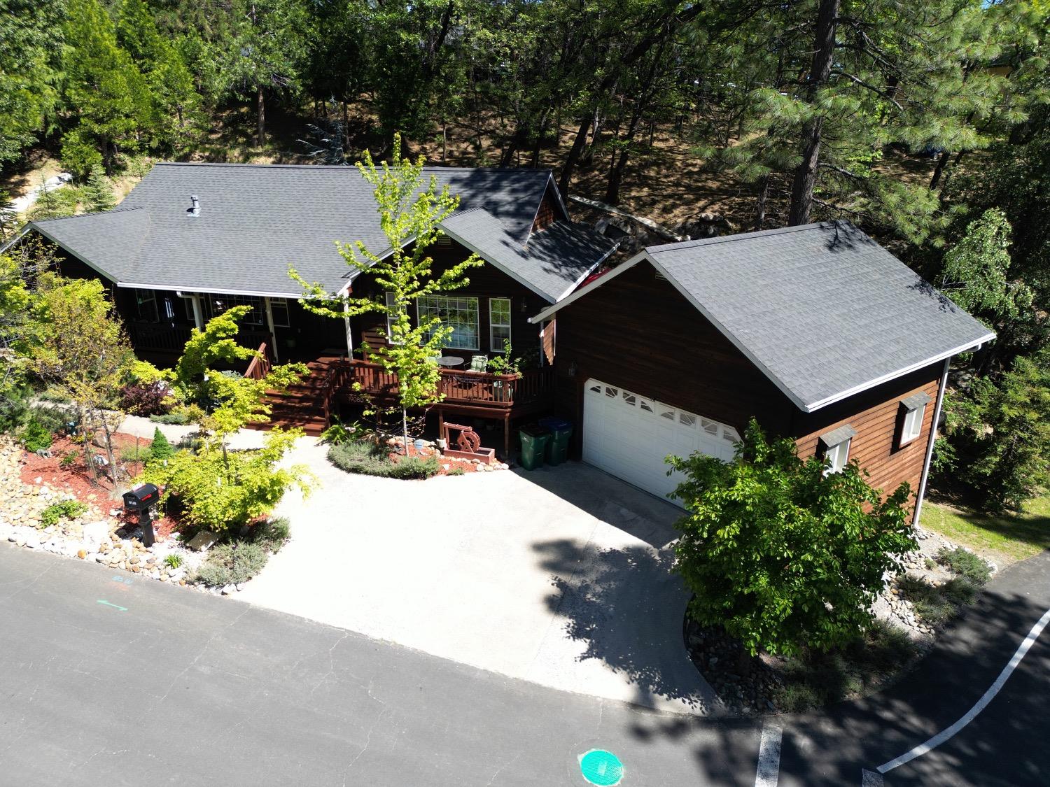 an aerial view of a house with table and chairs and potted plants