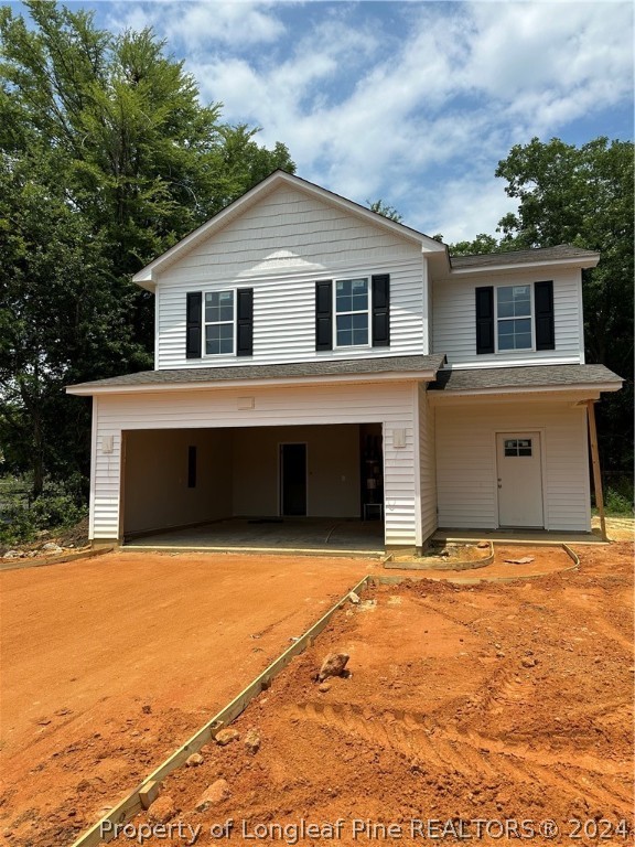 a front view of house with yard and garage