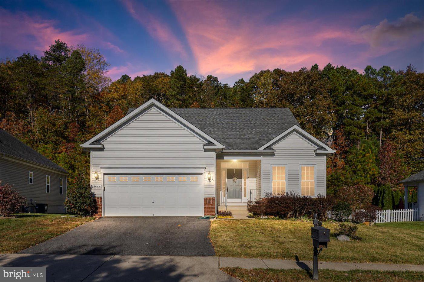 a view of a house with a yard and tree s