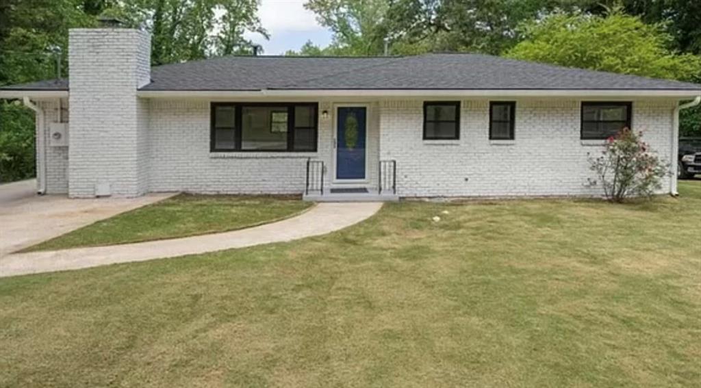 a view of a house with yard and a garage