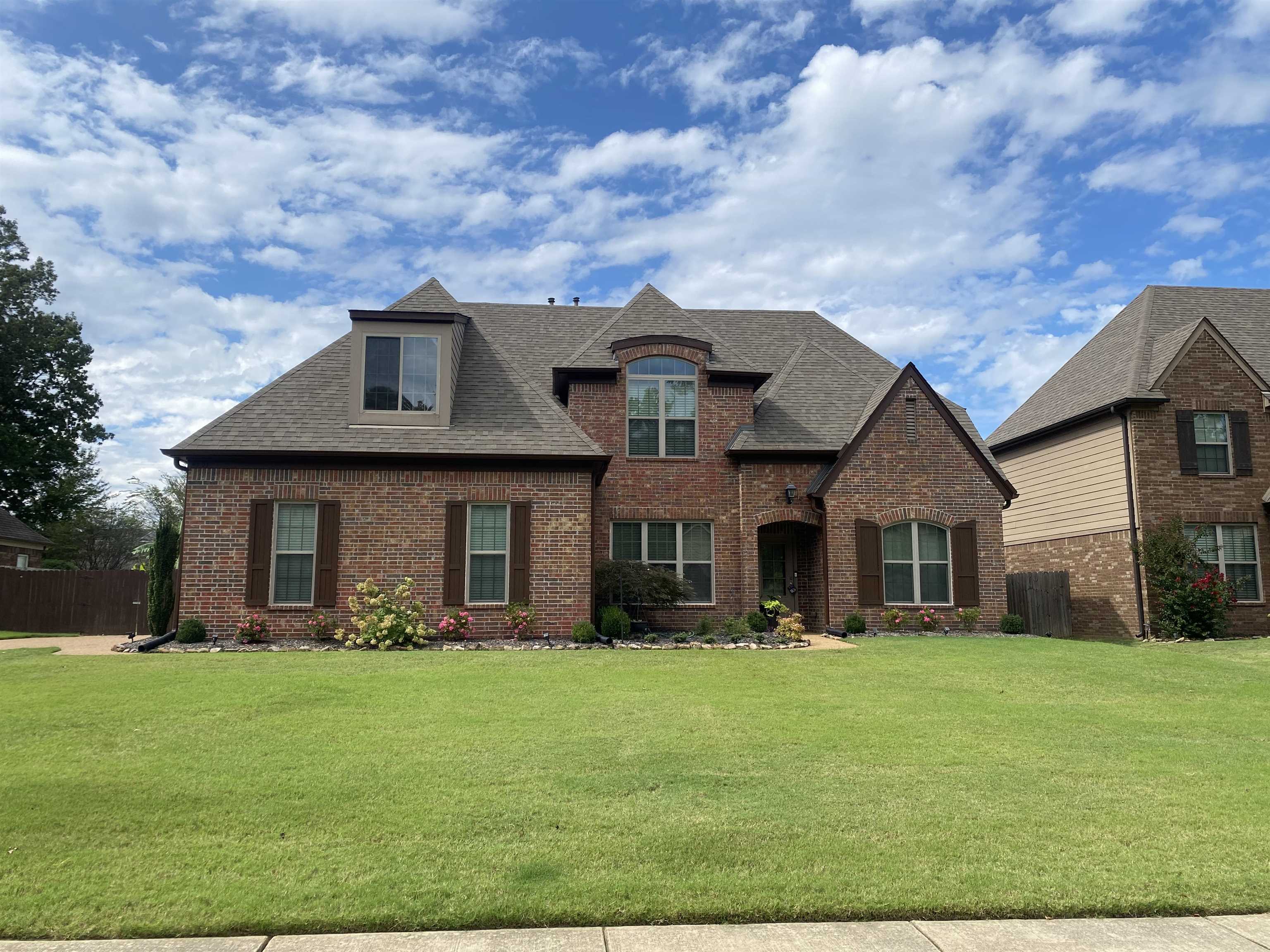 a front view of a house with a yard