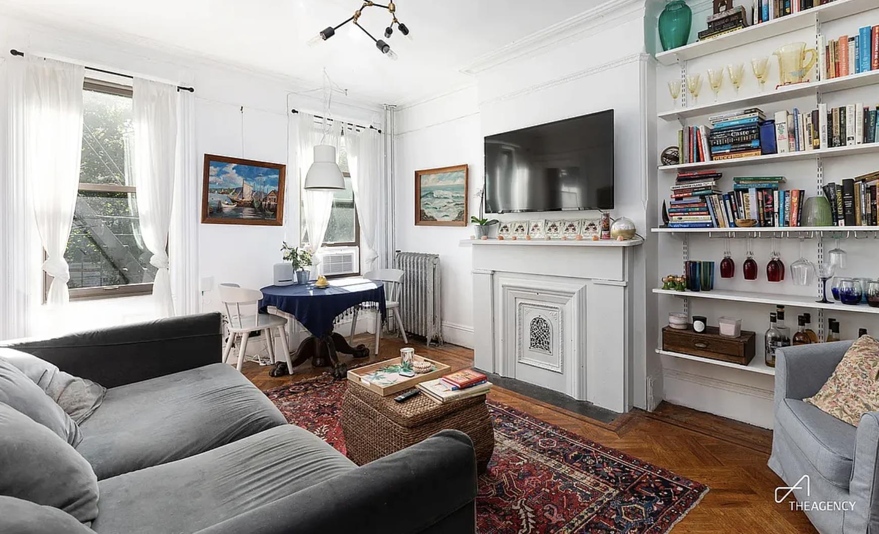 a living room with furniture fireplace and flat screen tv