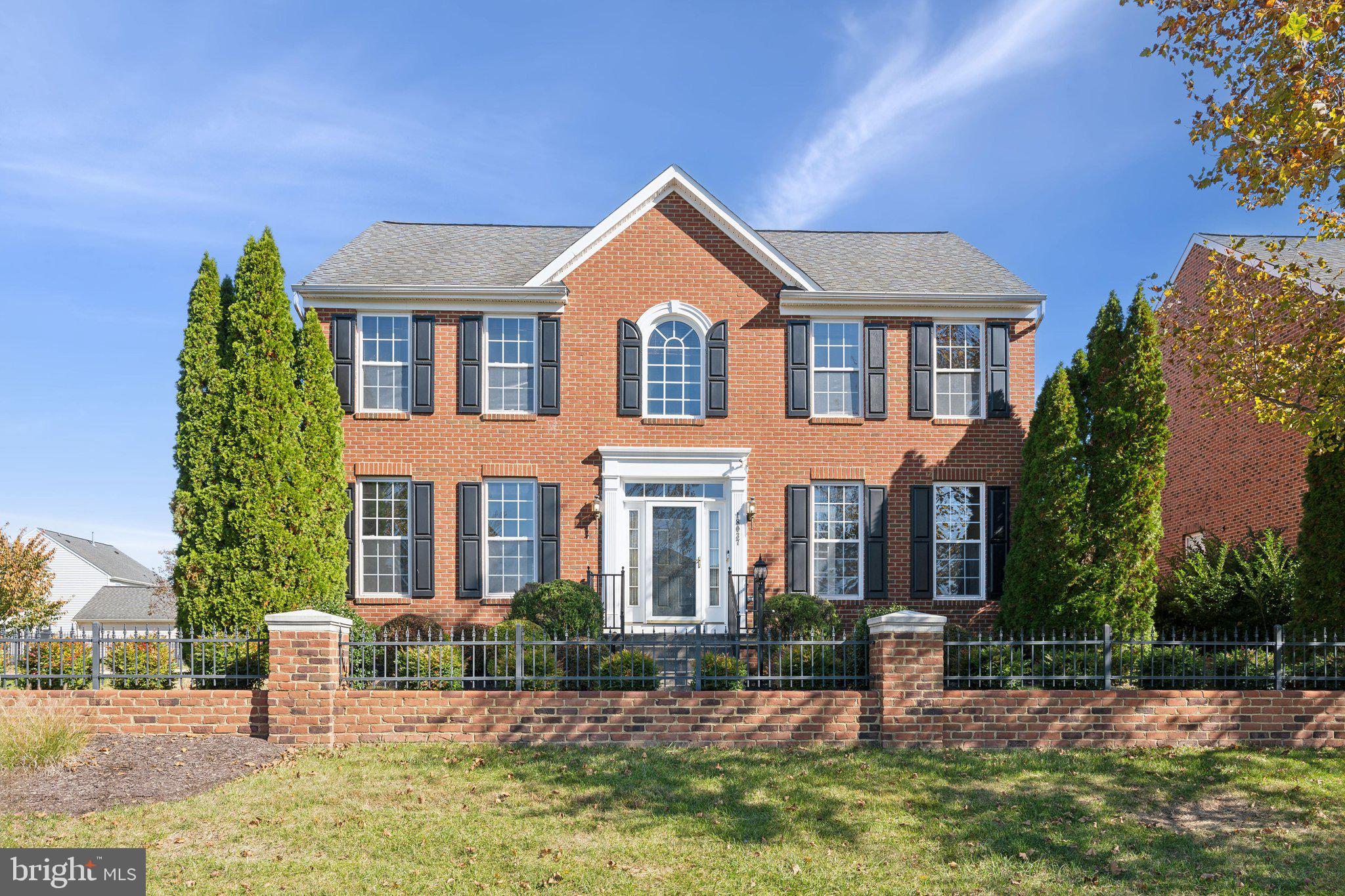 a front view of a house with yard and green space