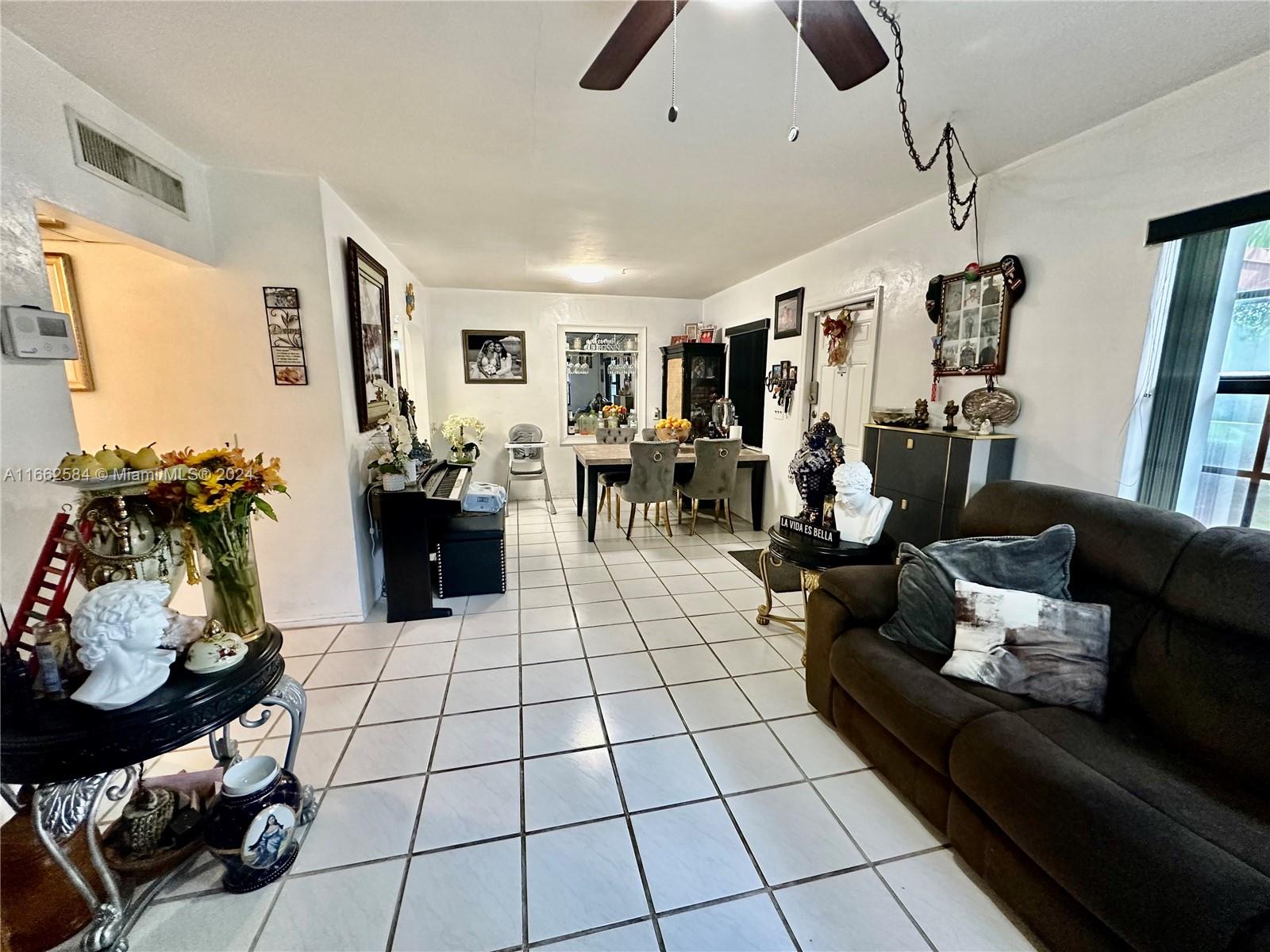 a living room with furniture and a floor to ceiling window