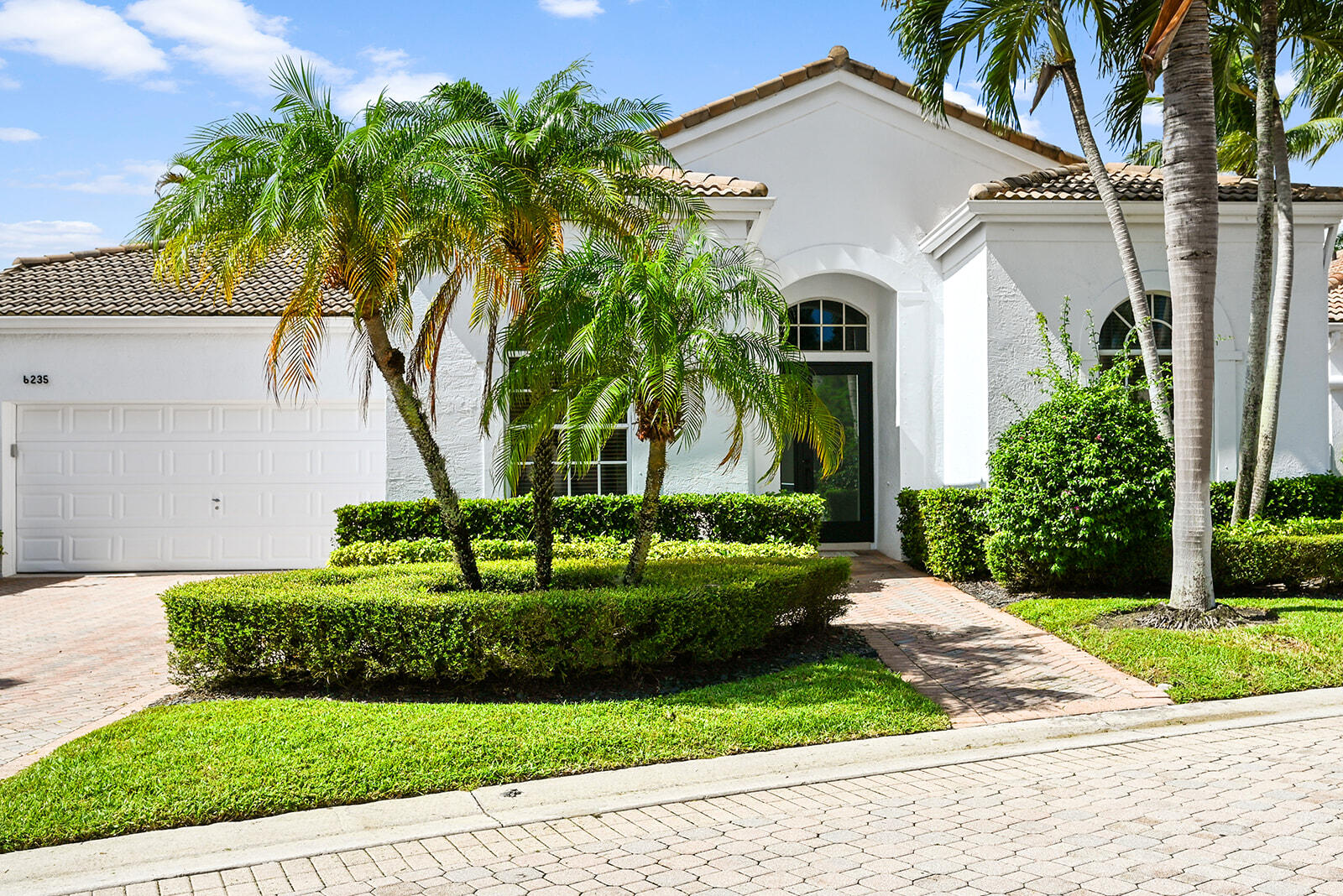 a front view of a house with a garden