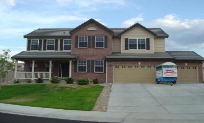 a front view of a house with a garden and yard