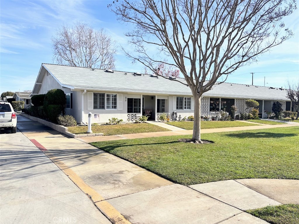 a view of a house with swimming pool and a yard