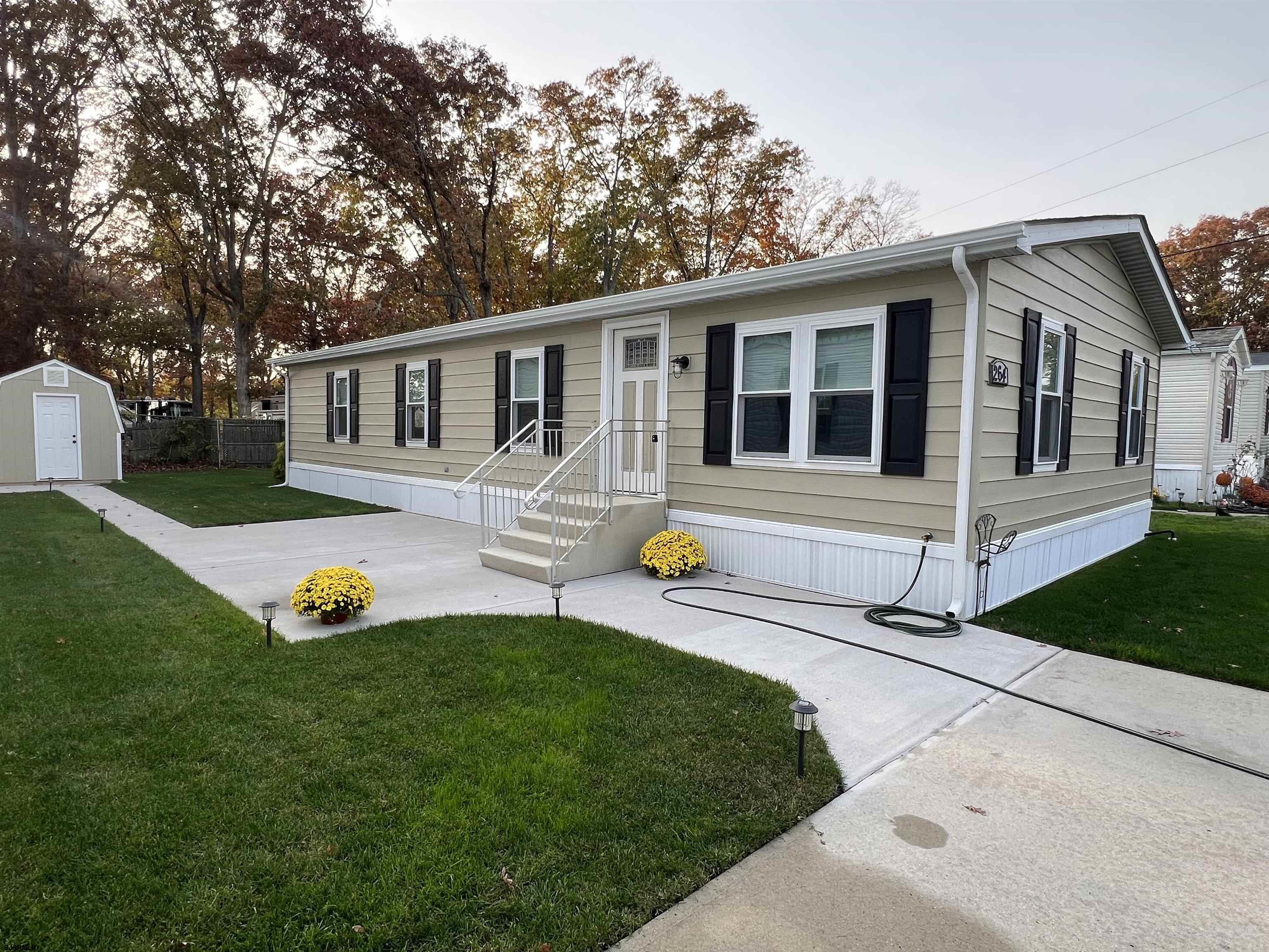 a front view of house with yard and outdoor seating