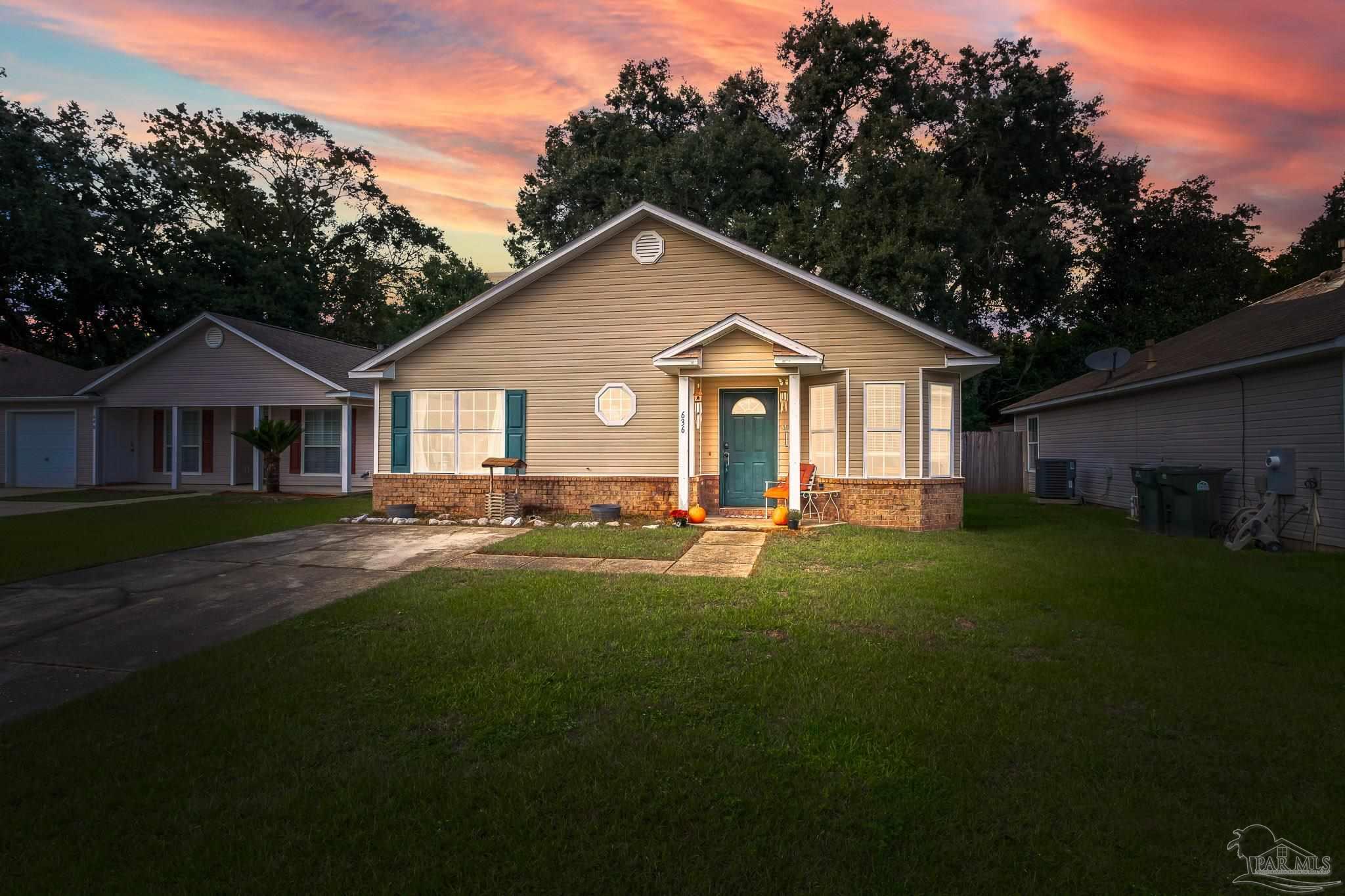 a front view of a house with a garden