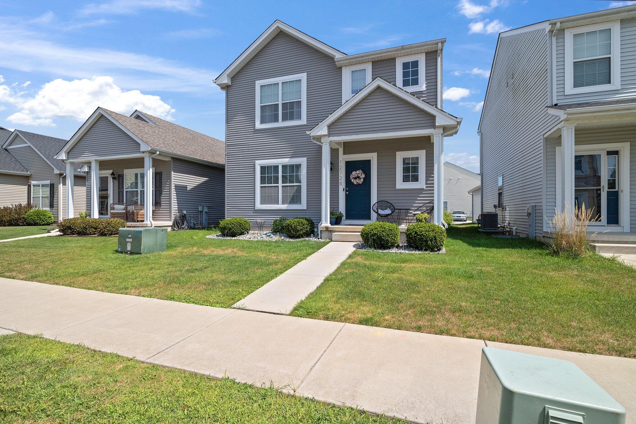 a front view of a house with a yard