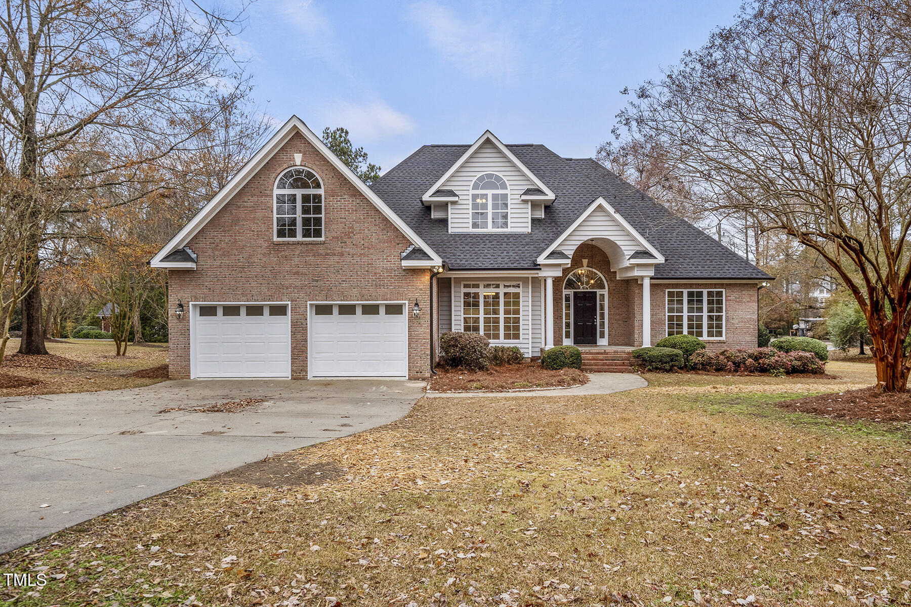 a front of a house with a yard and garage