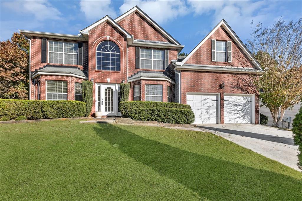 a front view of a house with a yard