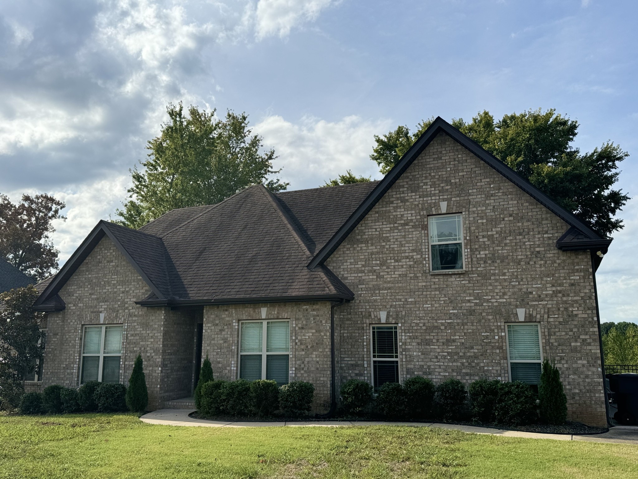 a front view of a house with a garden