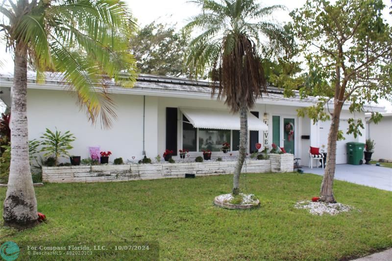 a front view of a house with swimming pool and furniture