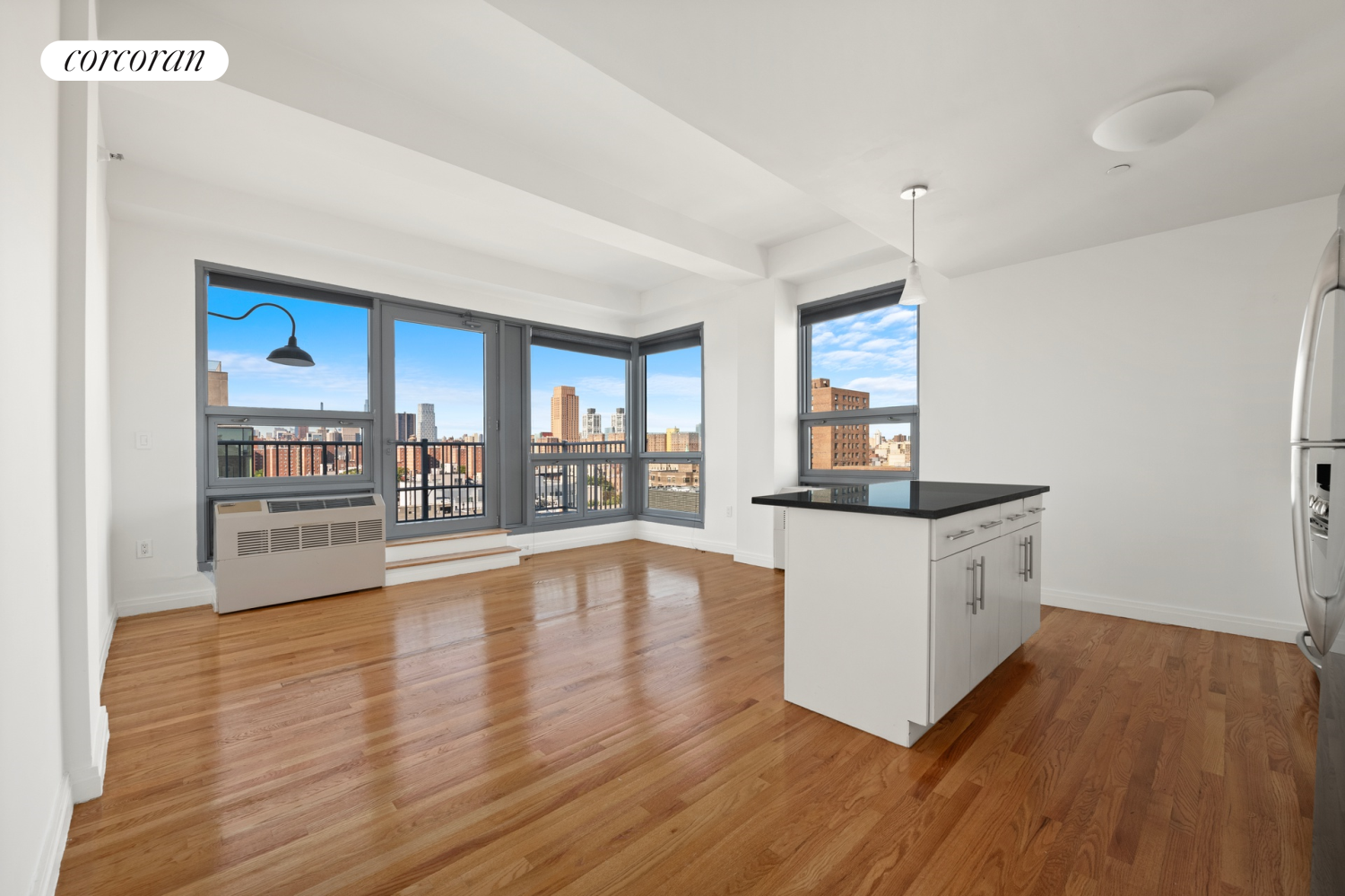 a room with wooden floors and large window