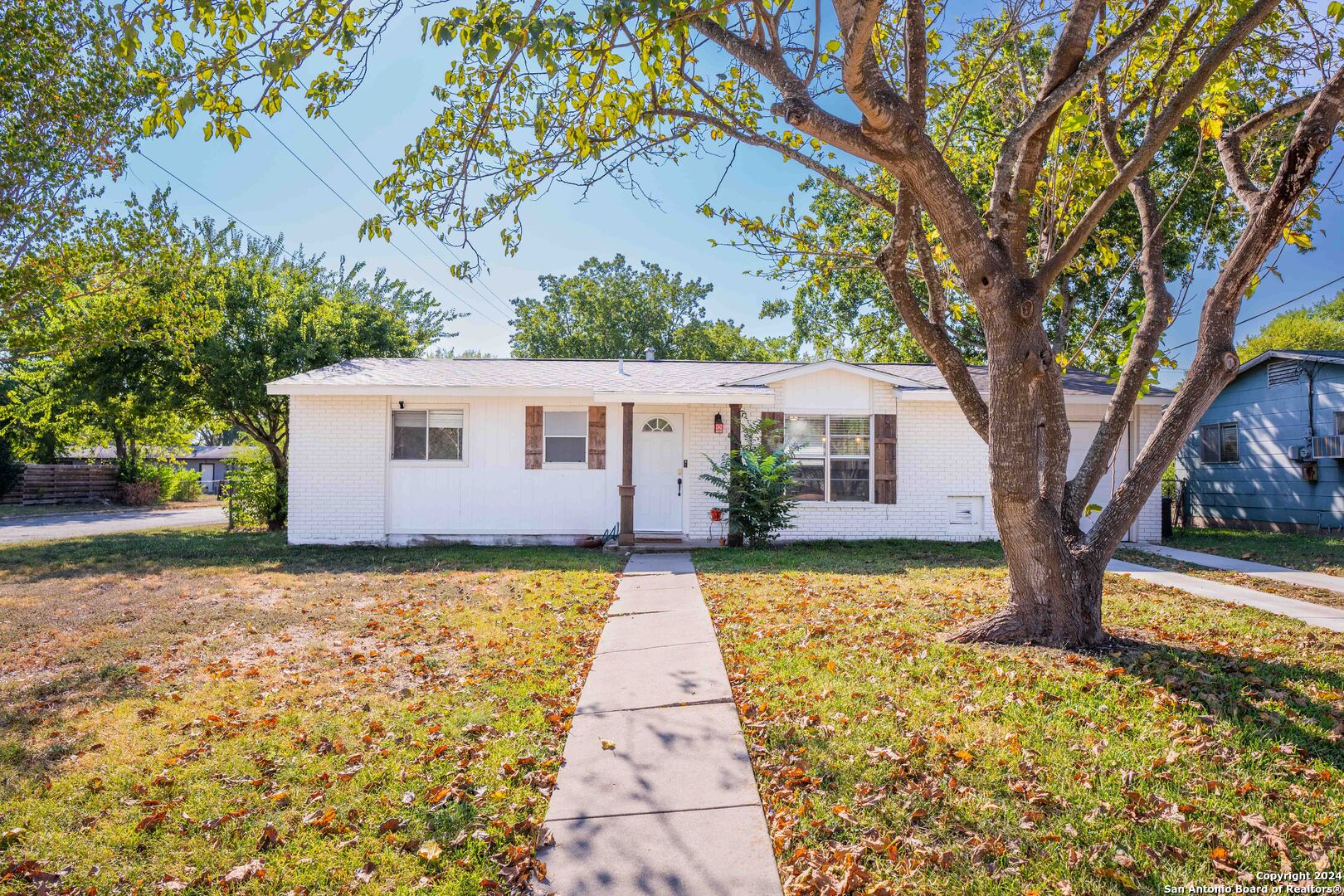 a front view of house with yard and trees