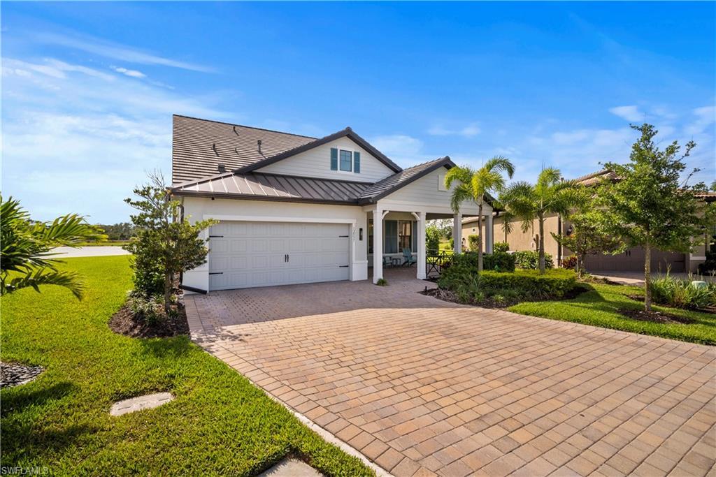 View of front of house featuring a garage and a front lawn