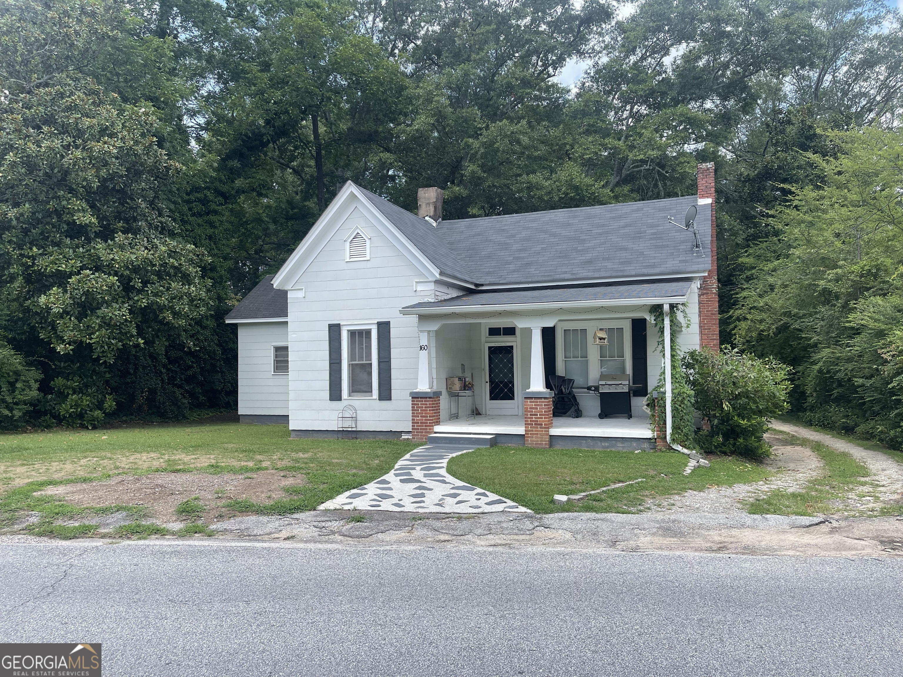 a front view of a house with a yard and porch