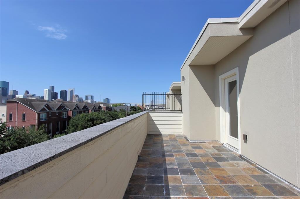 a view of a balcony with wooden floor and fence