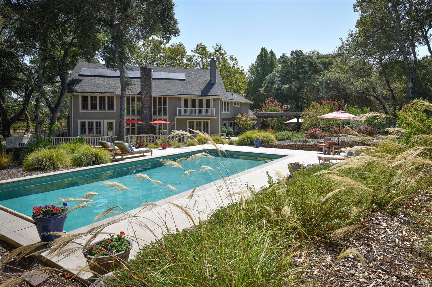 a view of a house with backyard and sitting area