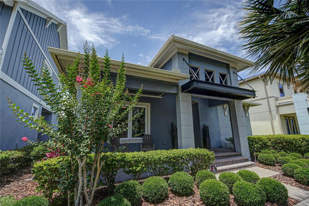 a front view of a house with plants