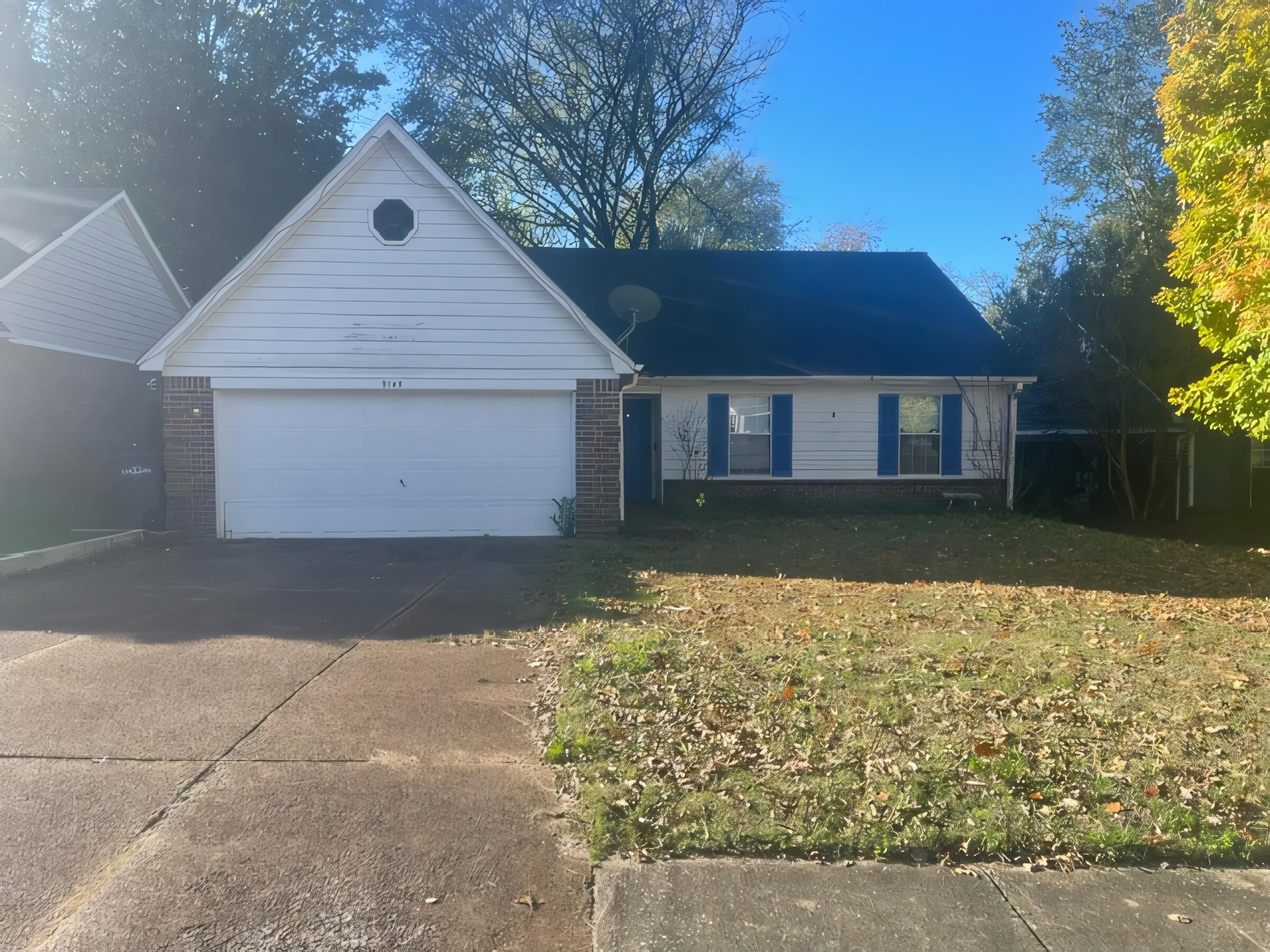 Ranch-style home with a garage and a front yard