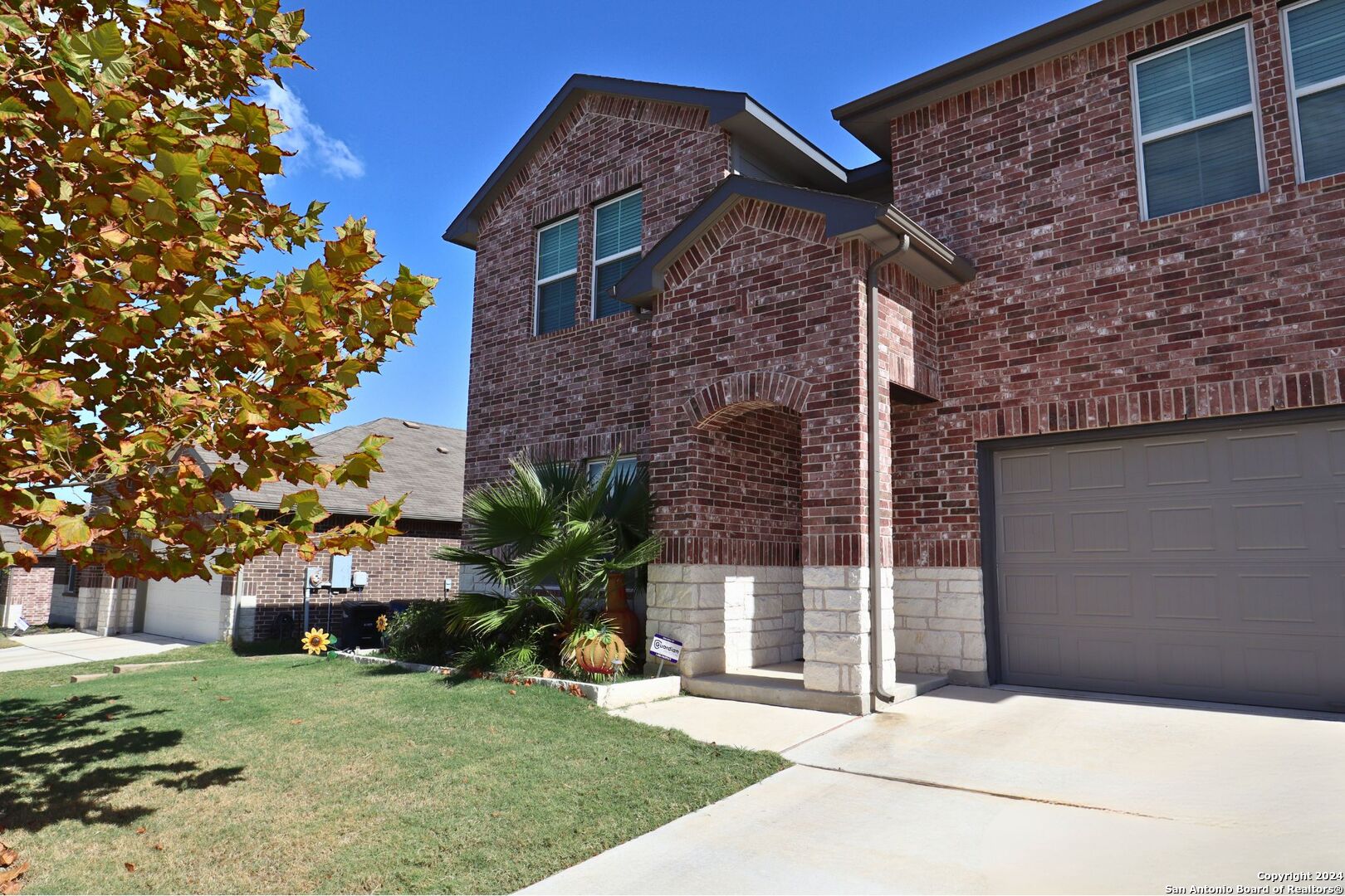 a brick building with a yard in front of it