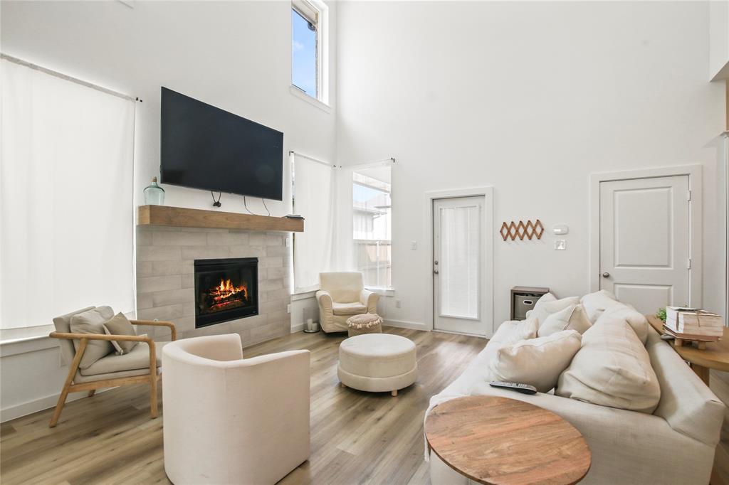 a living room with furniture a fireplace and a flat screen tv