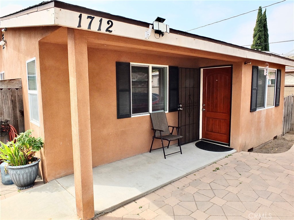 a front view of a house with outdoor seating