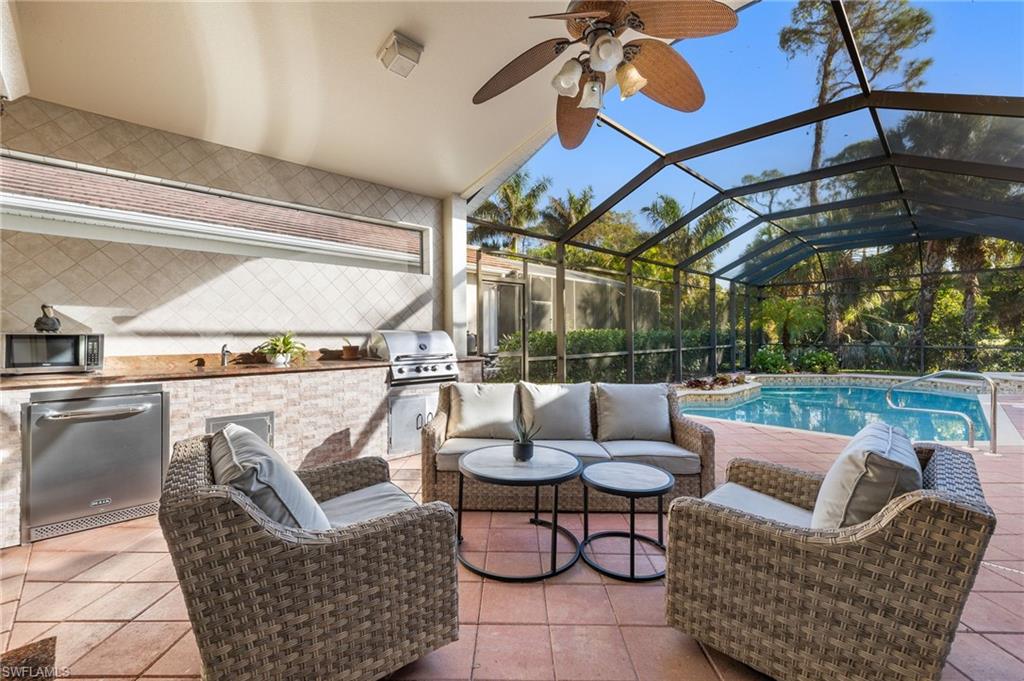 Fabulous Indoor/Outdoor Living! Outdoor Kitchen + convenient Electric Hurricane Shutters for covered lanai.