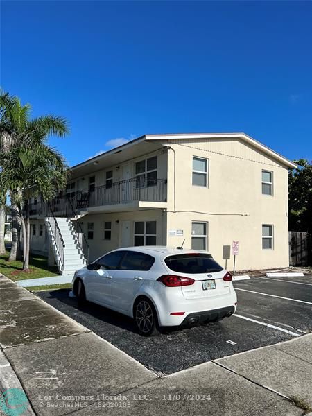 a front view of a house with parking space