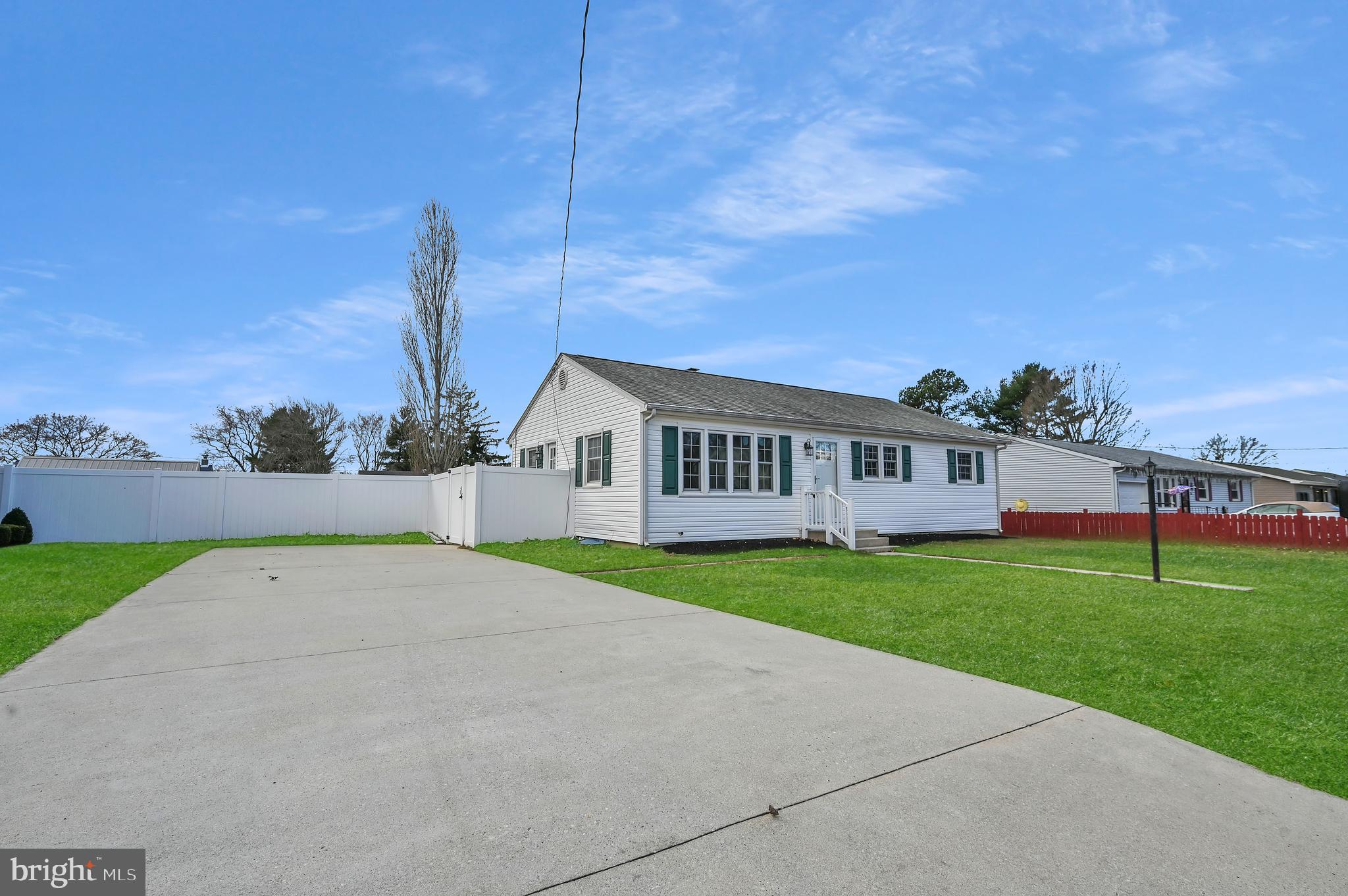 a view of a house with a yard and a garden