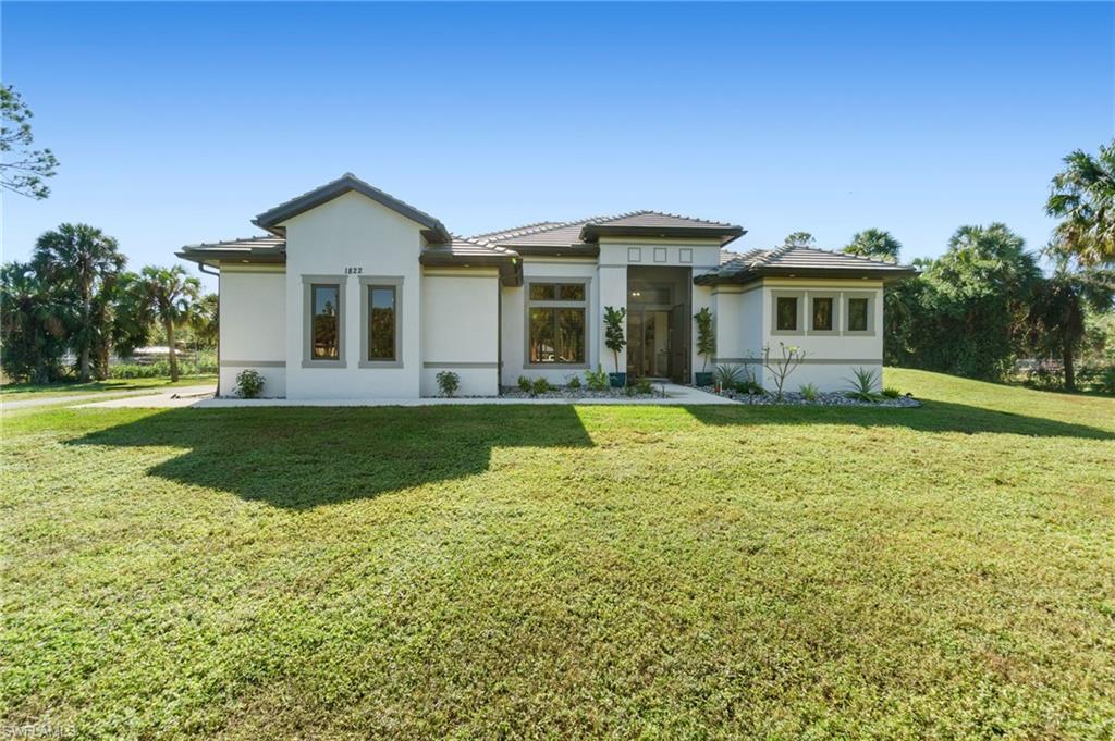 a front view of a house with a yard