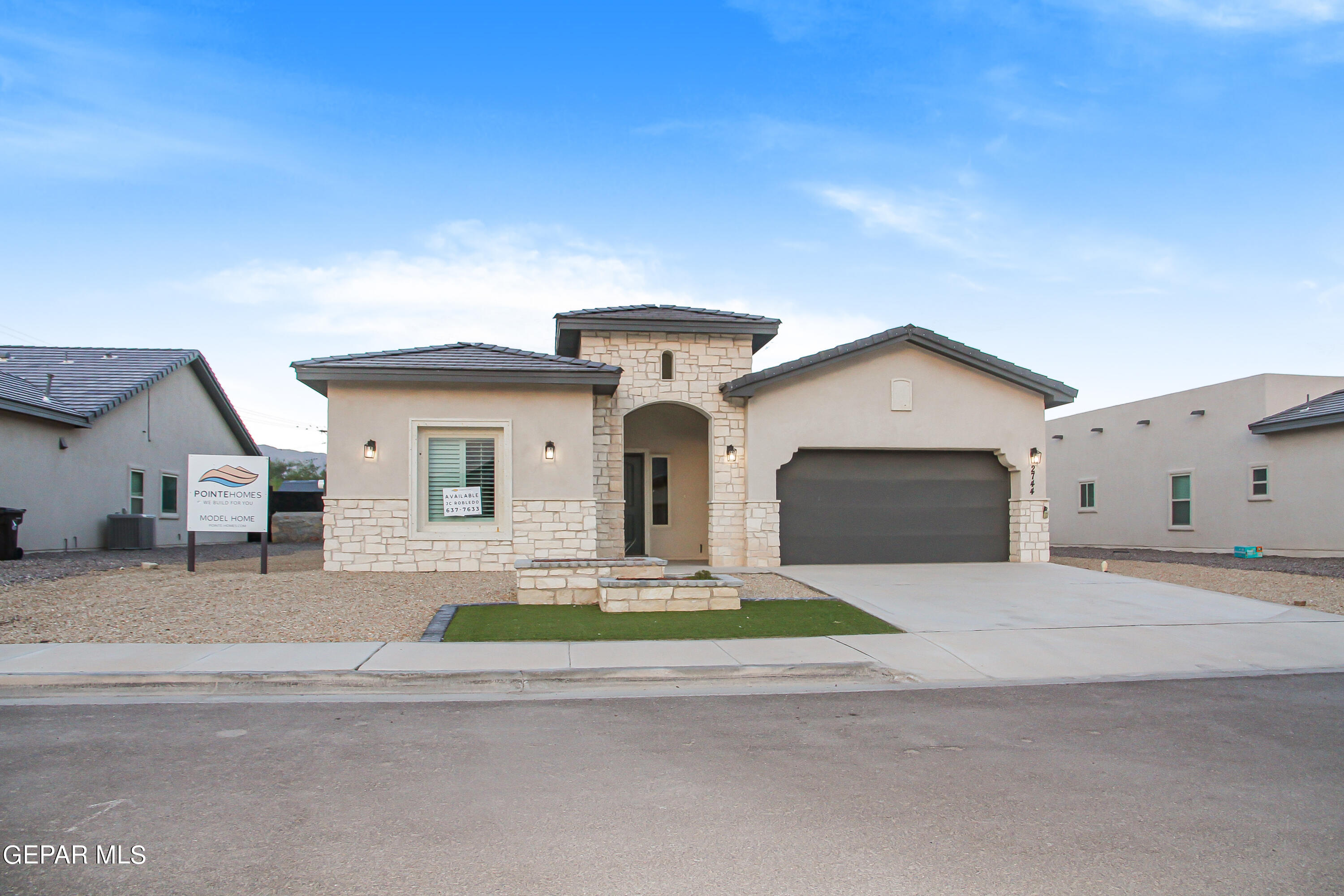 a front view of a house with a yard and garage