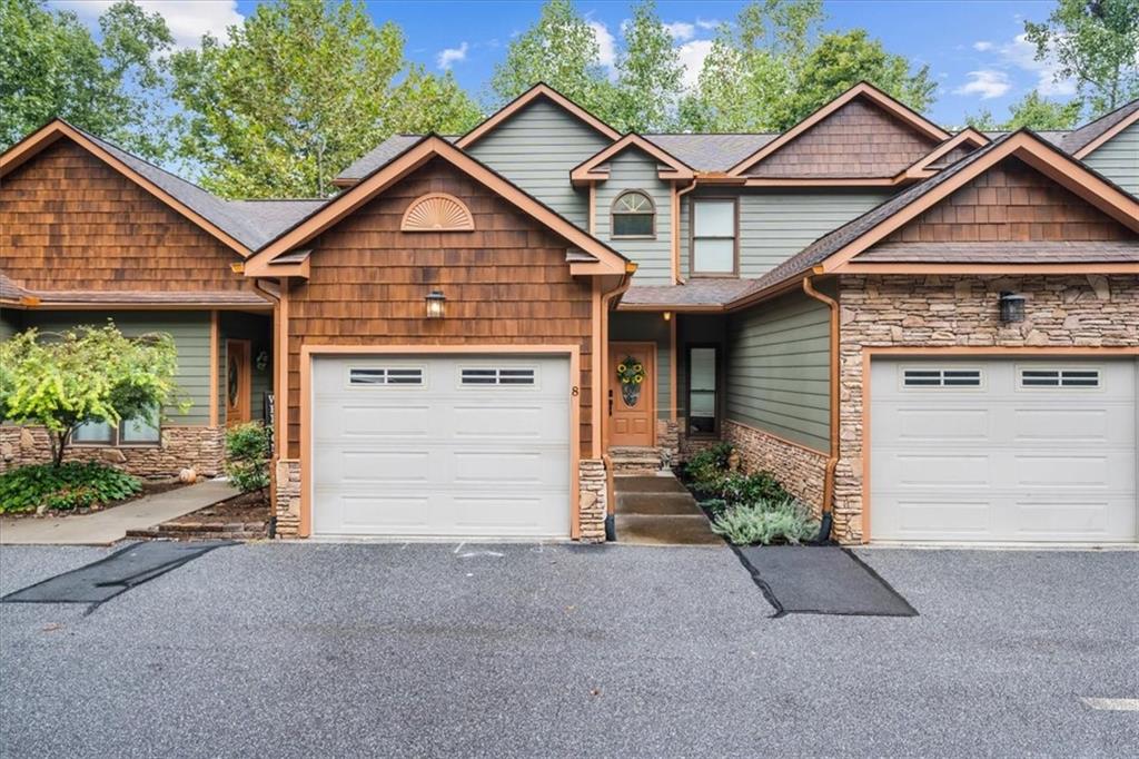 a view of a house with a yard and garage