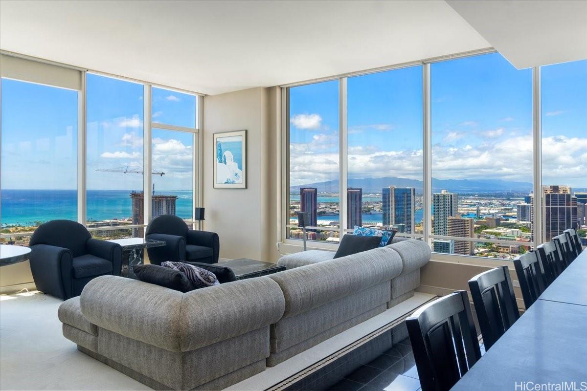 a living room with furniture city view and large windows