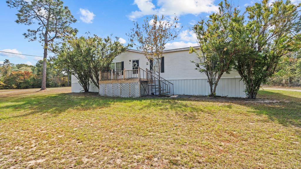 a view of a house with a yard and tree s