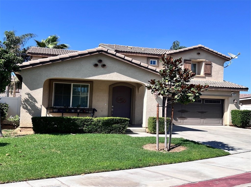 a front view of a house with a garden