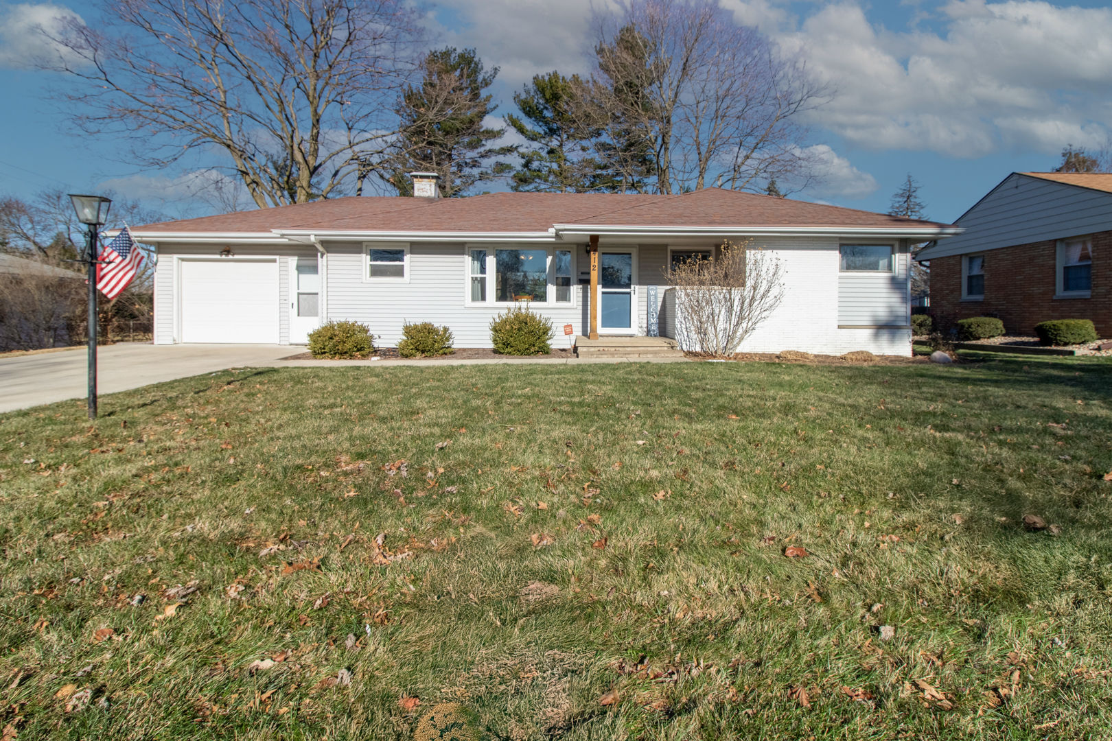 a front view of a house with a garden