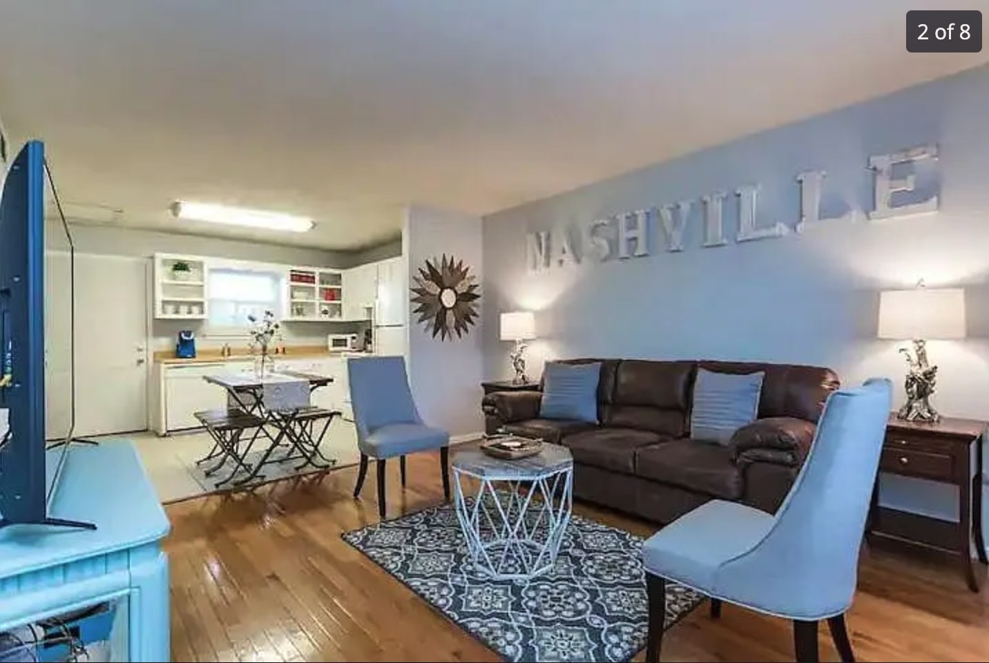 a living room with furniture wooden floor and a table