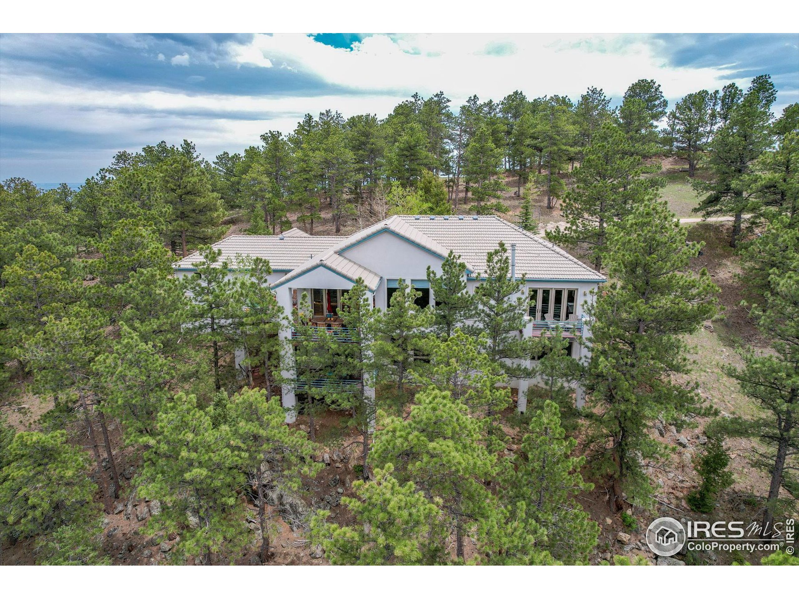 a aerial view of a house with yard and outdoor seating