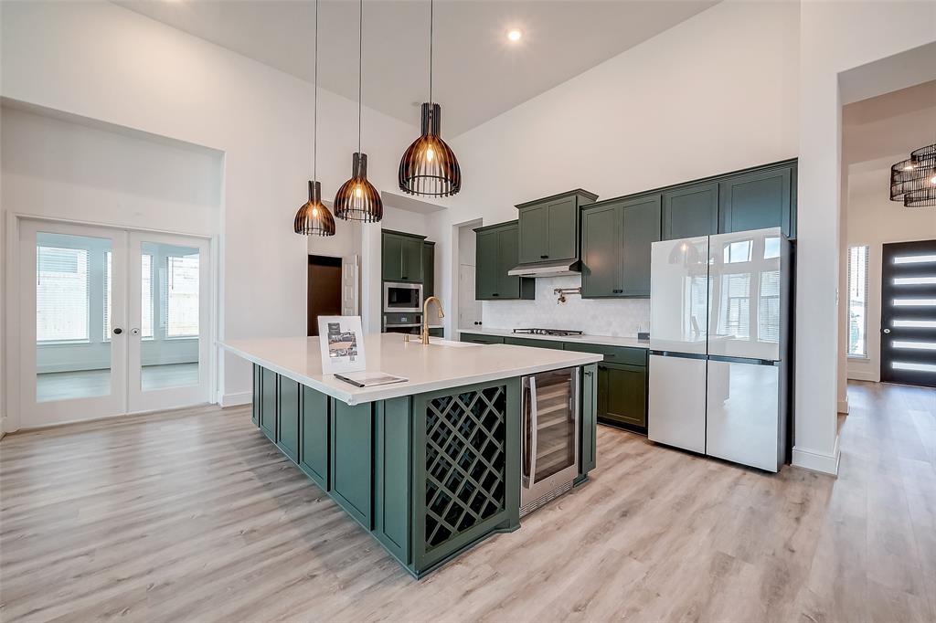 a kitchen with stainless steel appliances a stove cabinets and wooden floor