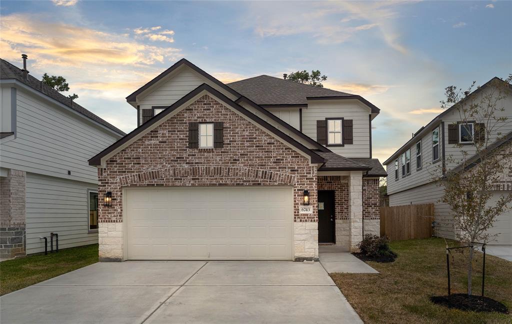 a front view of a house with garage