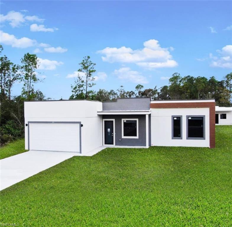 a house with green field in front of it