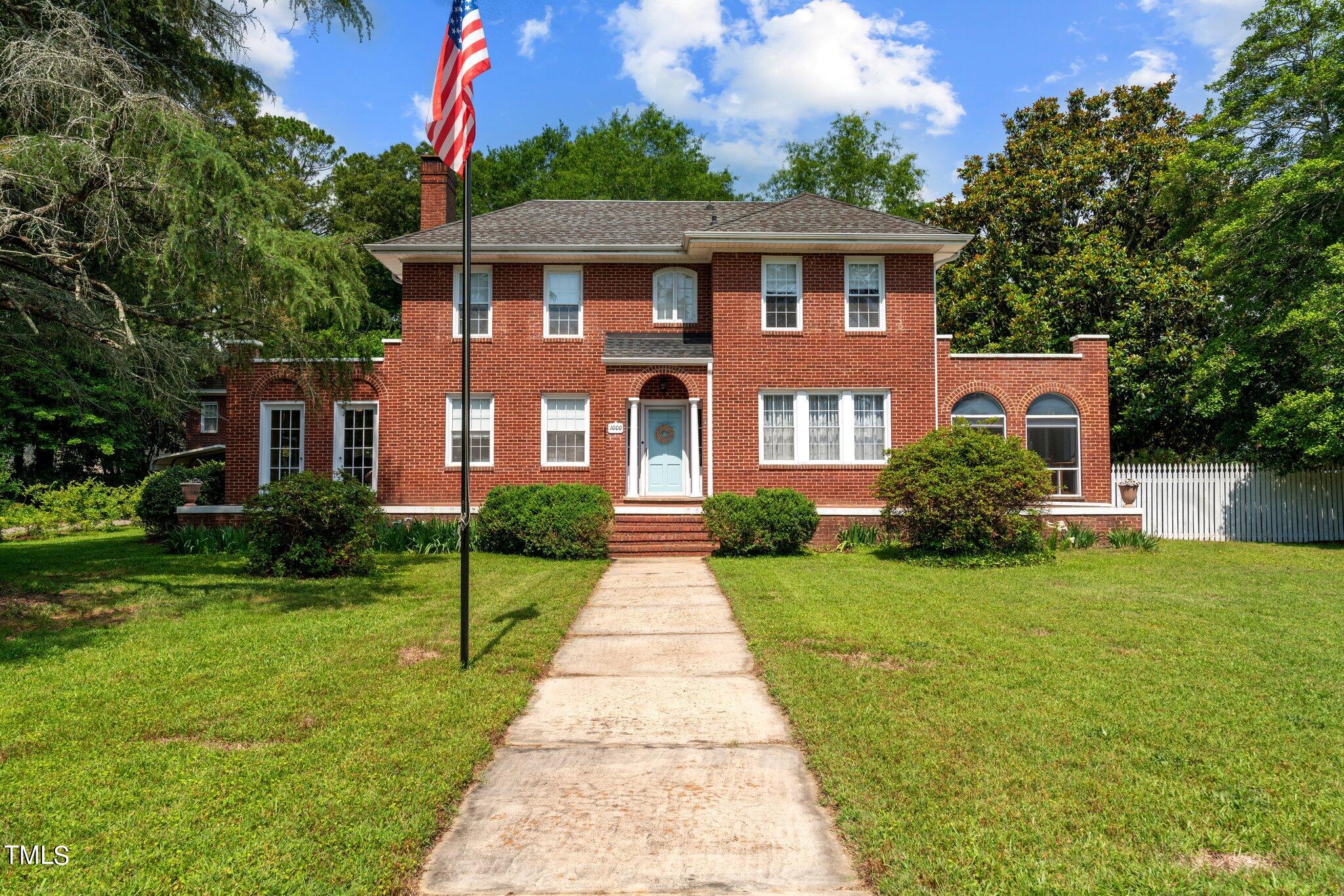 a front view of a house with yard