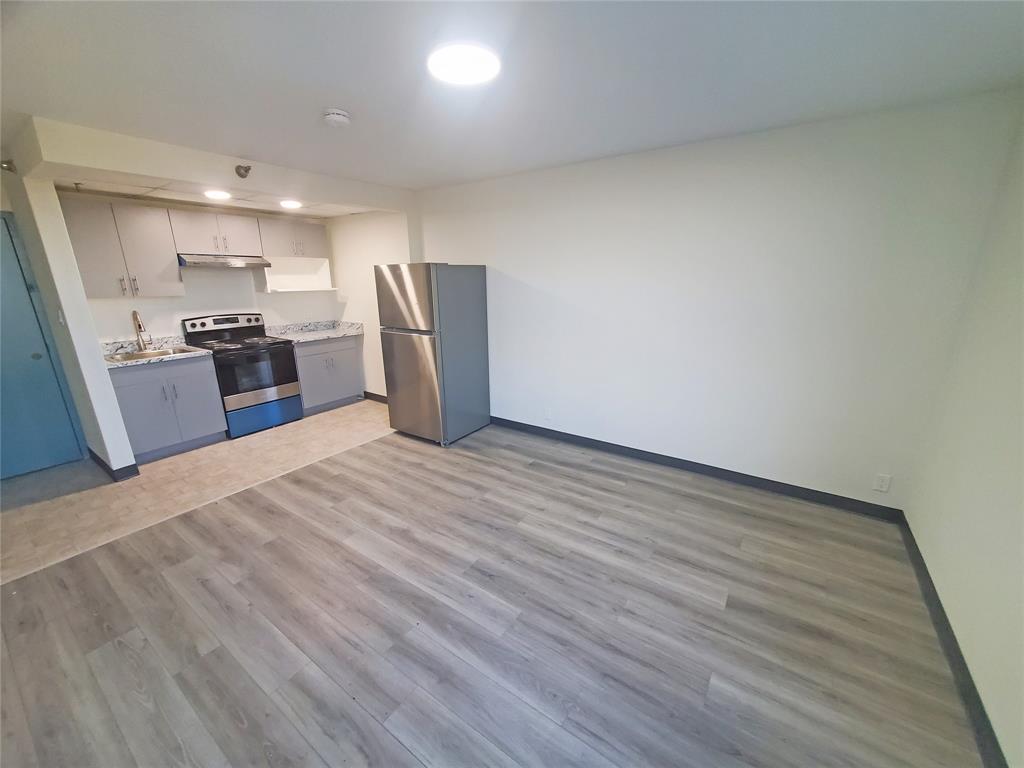 a view of kitchen with refrigerator microwave and stove