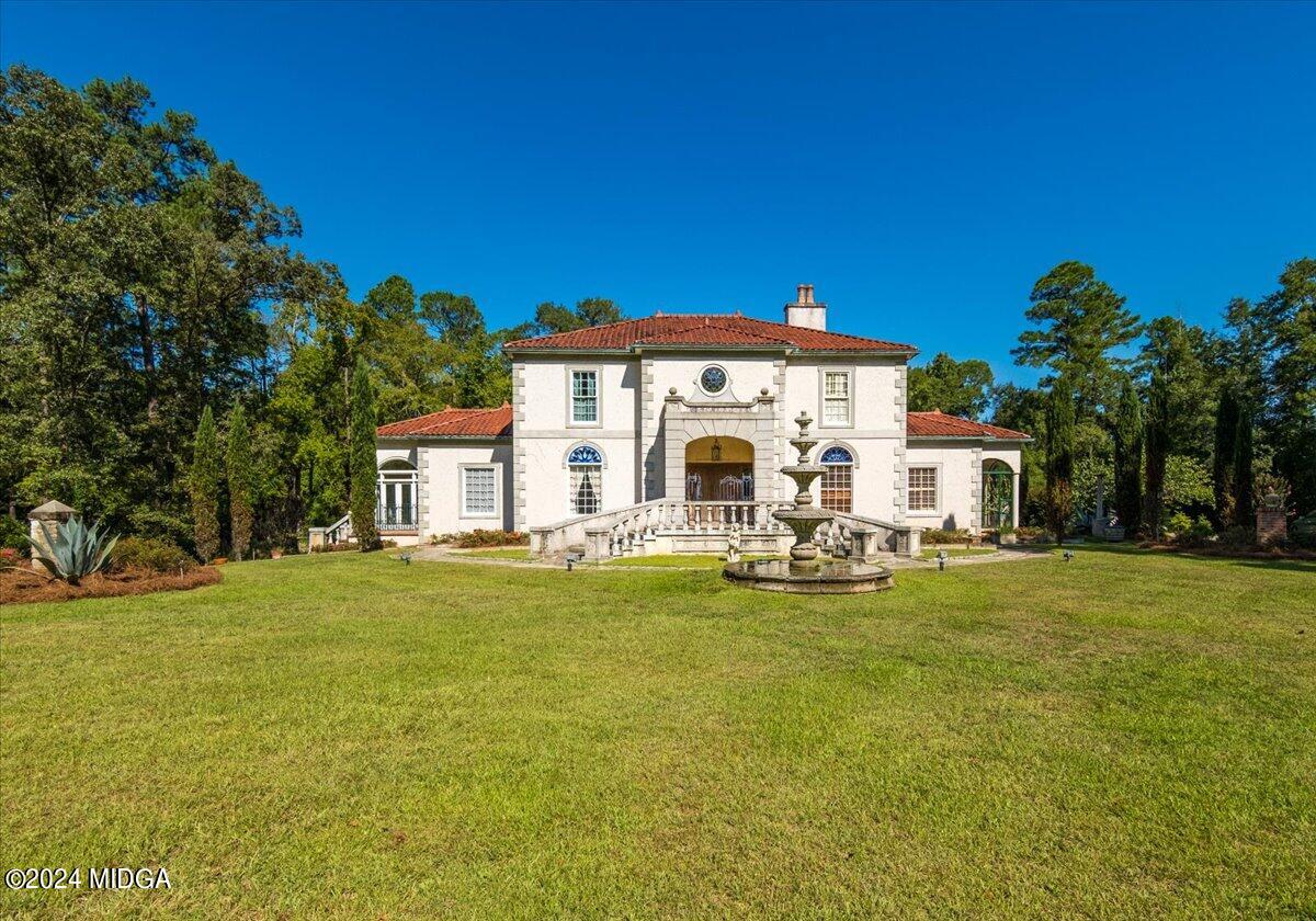 a view of a house with swimming pool and sitting area